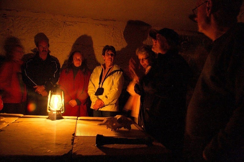 A group of people standing around a table