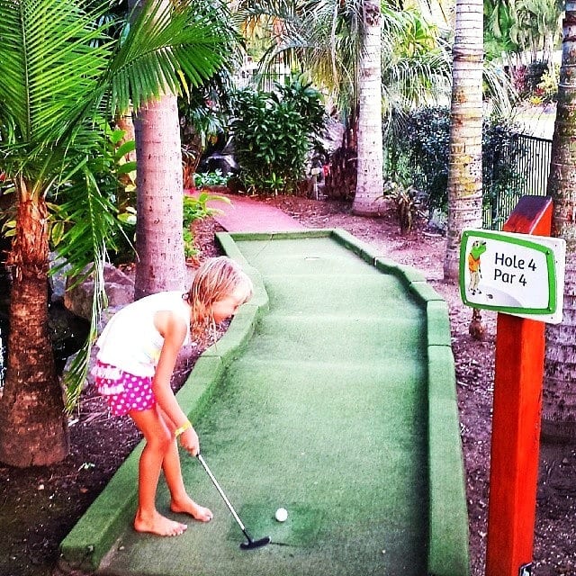 girl playing mini golf