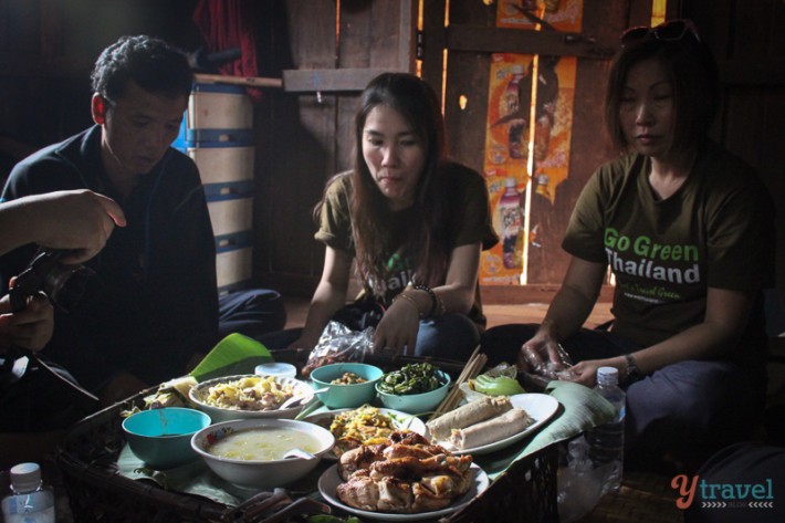 people eating a meal together in  bamboo hut