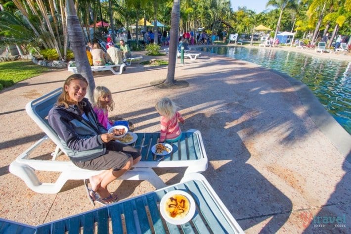 family eating pancakes by pool