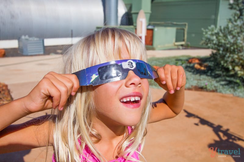 girl wearing paper glasses