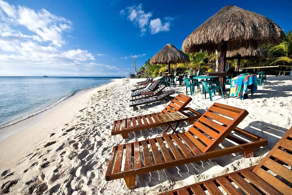 wooden lounge charis on beach at Cozumel, Mexico