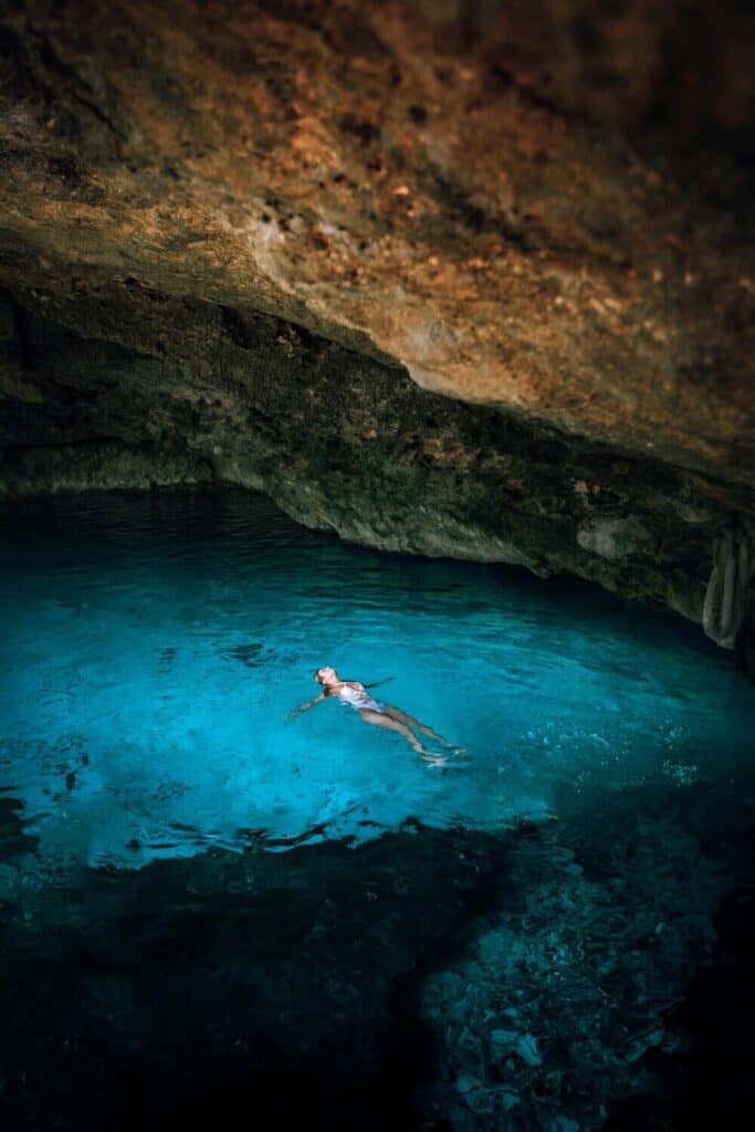 person swimming in cenote