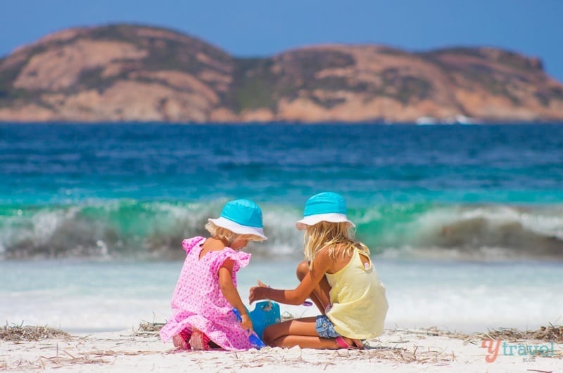 girls sitting on the beach