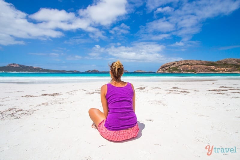 A woman sitting on the beach