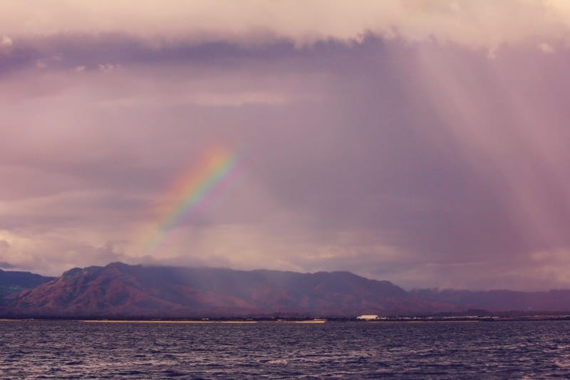 rainbow over mountains on island