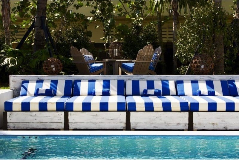 chaise lounges beside swimming pool