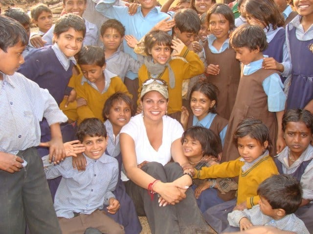 woman in crowd of kids in india