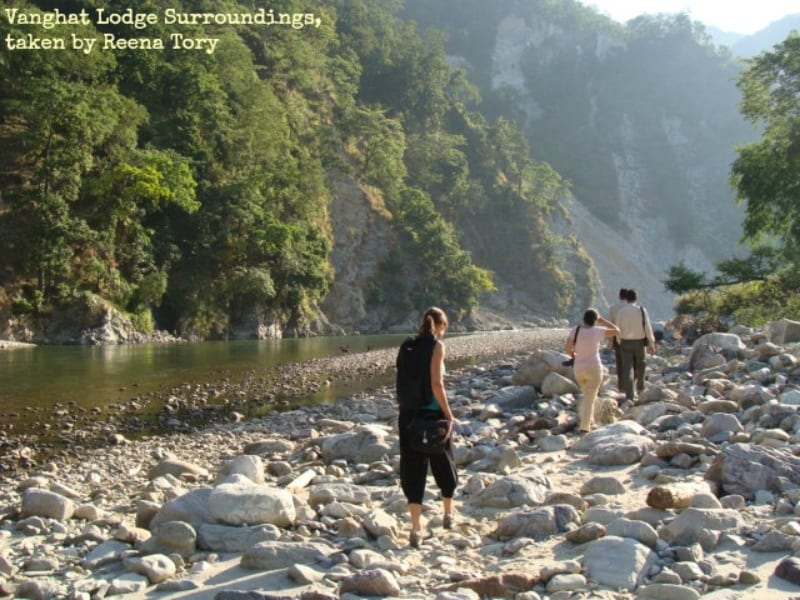 people walking along a rocky beach