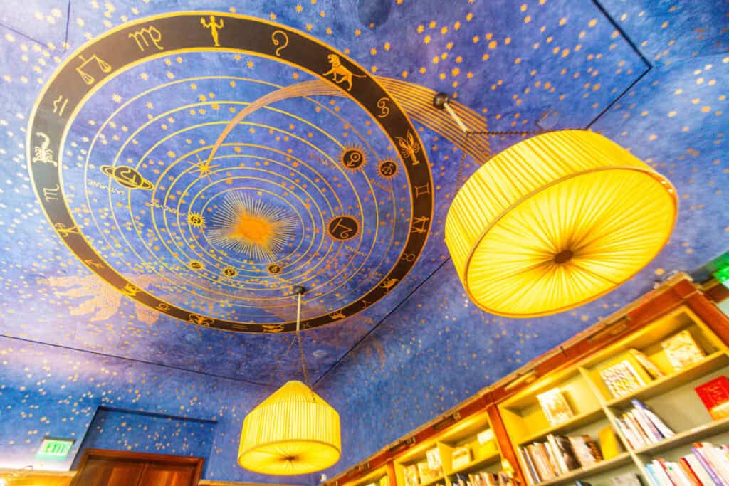 celling painted with blue sky and stars and astrological signs