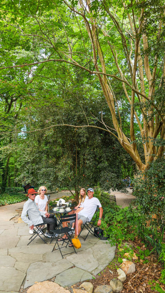 family sitting in forest enjoying coffee at cafe driade