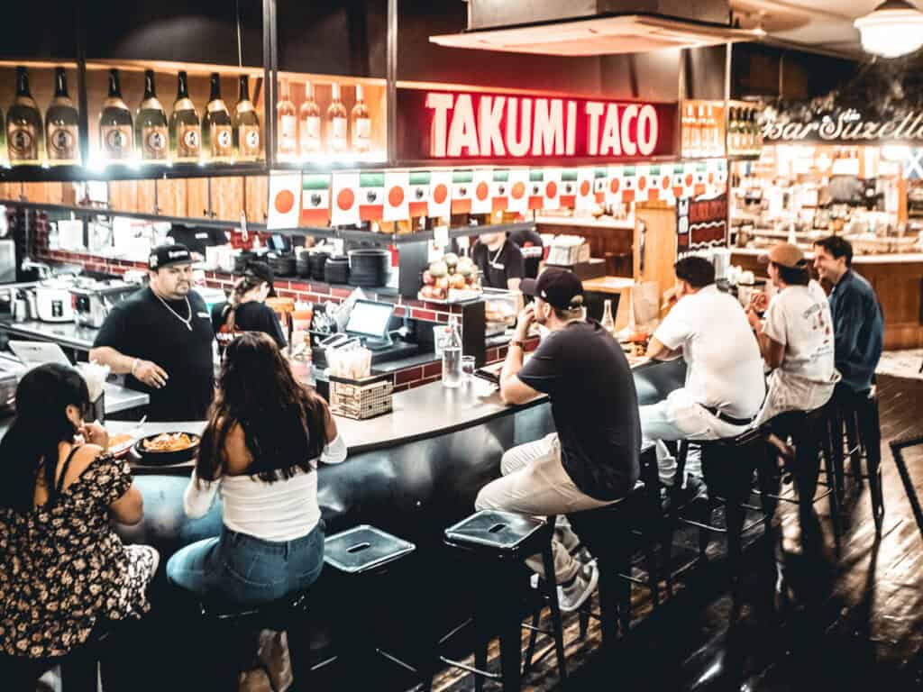 people sitting at Japanese food stall in chelsea markets