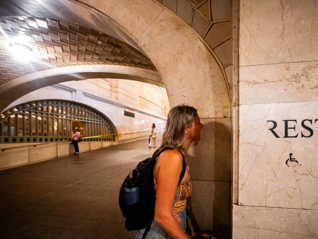 woman whispering into wall