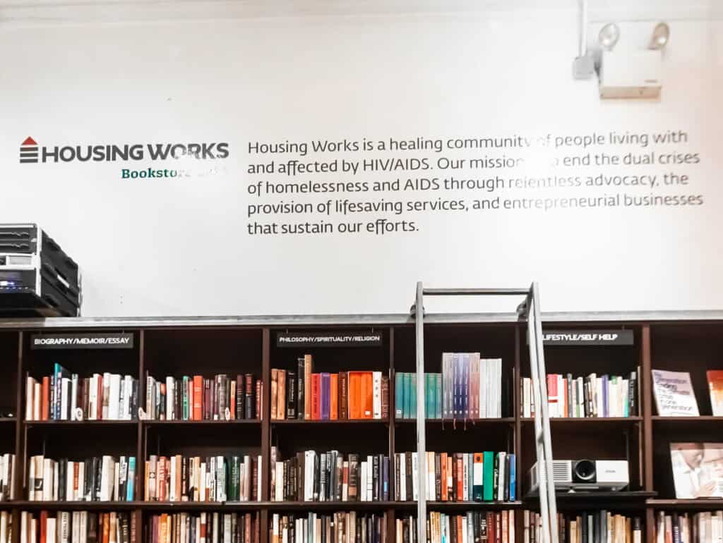 books on shelf with housing works mission above