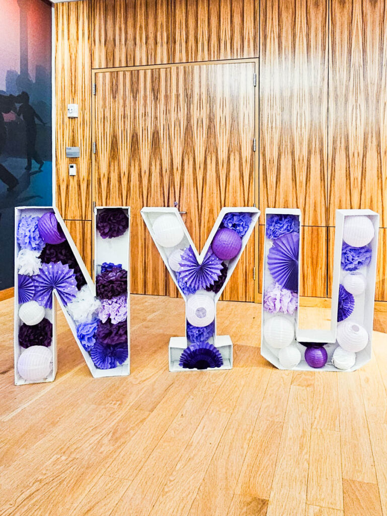 purple NYU sign