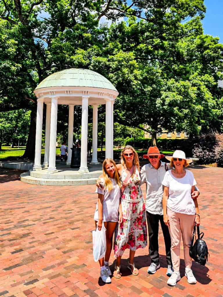 family posing in front of Old Well White