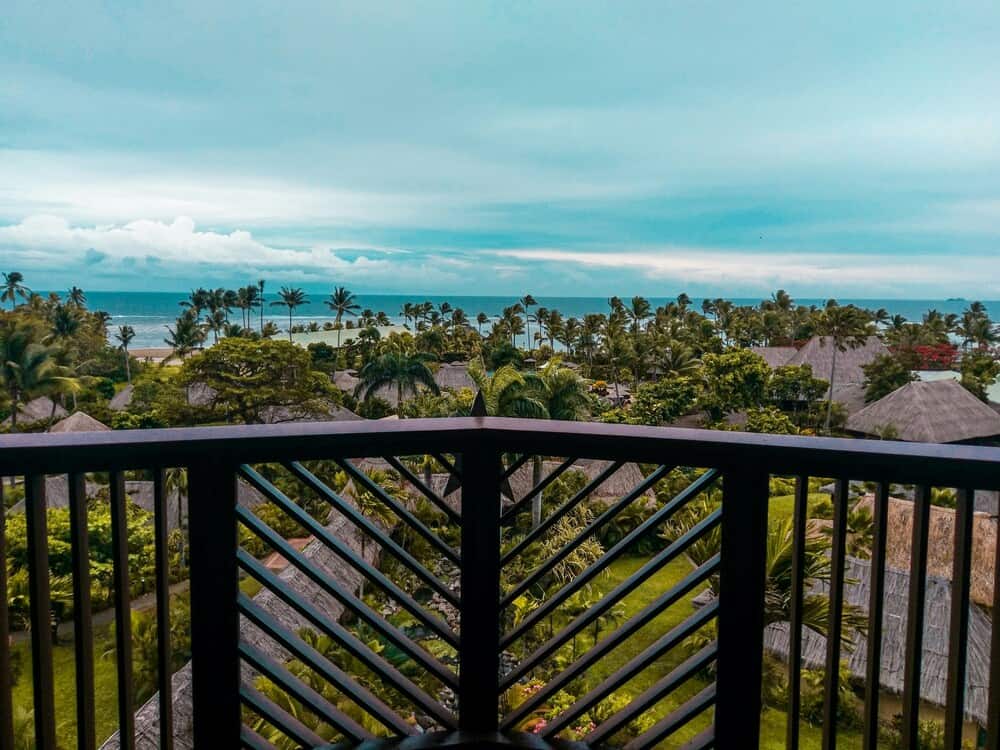 view of distant beach and palm trees in Fiji