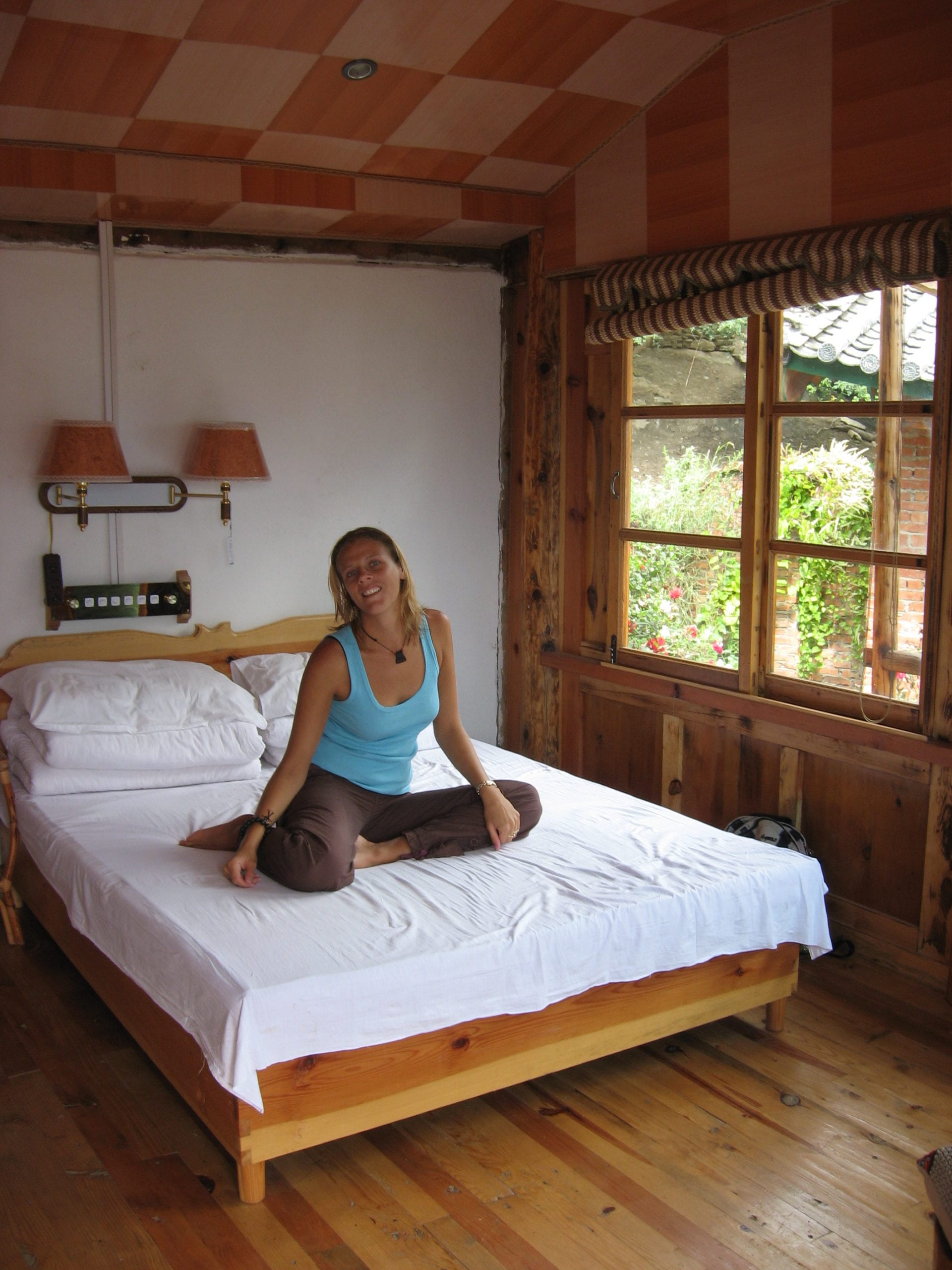 woman sitting on hostel bed