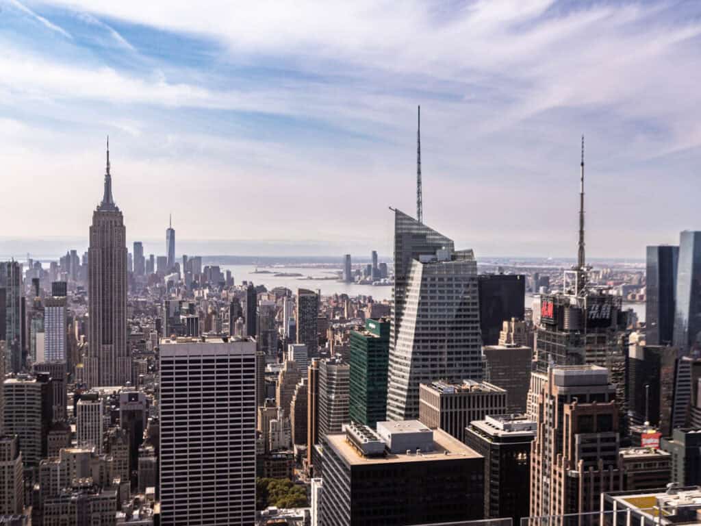 view of empire state building and hudson river from top of the rock