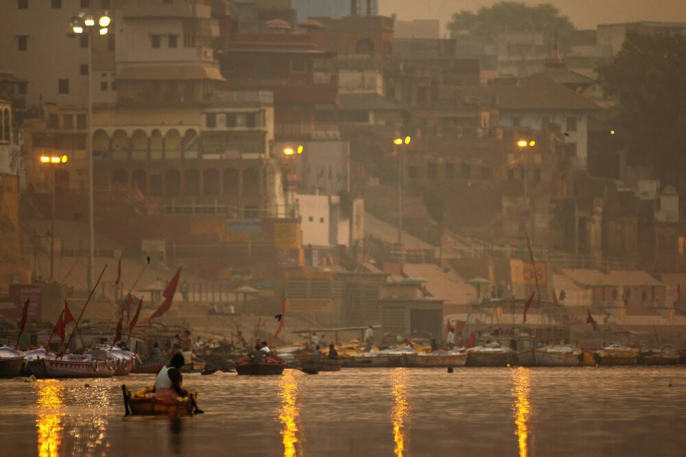 boats on a hazy river in varanasi india