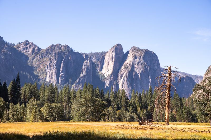 cathedral rock rising up from yosemite valley wider perspective