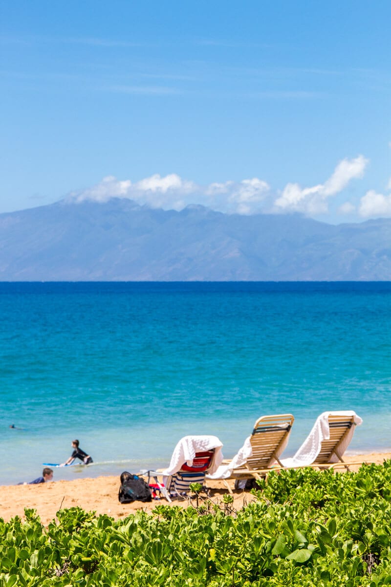 chairs on Kaanapali Beach looking at island in the distance