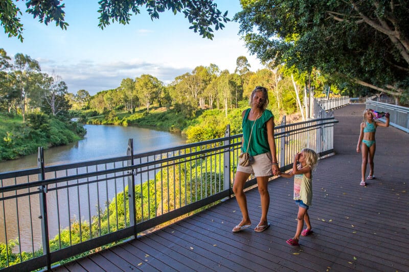 woman and child walking on riverwalk boardwalk