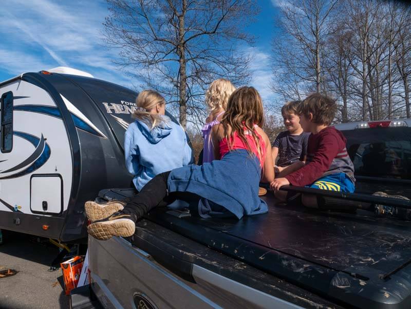 kids sitting on f250 truck bed