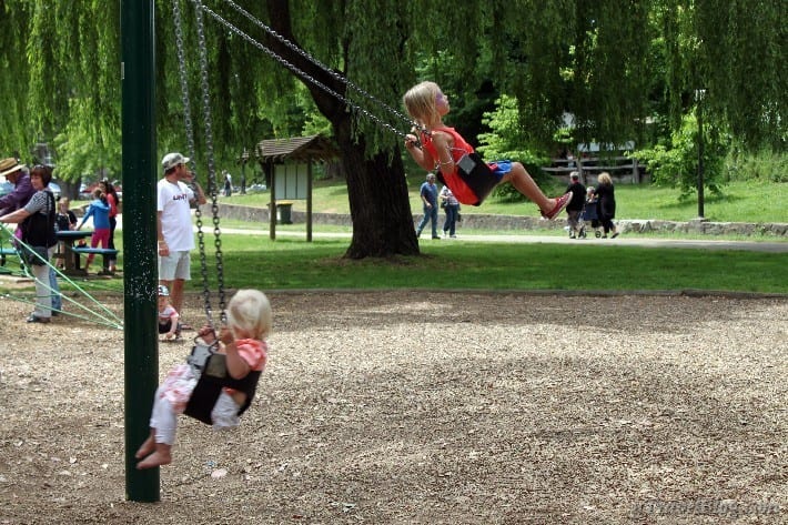 girls on swings at bright playground