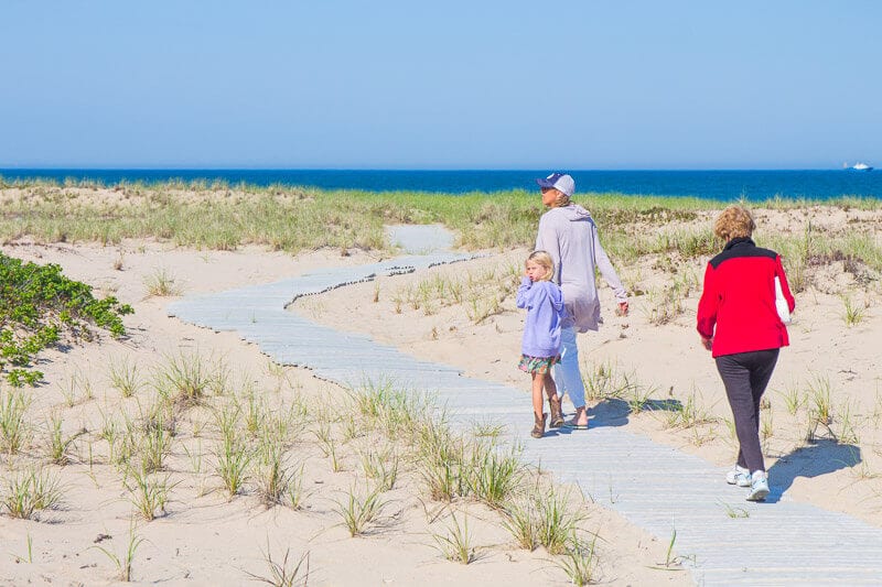 multigenerational family walking on beach path on martha's vineyard