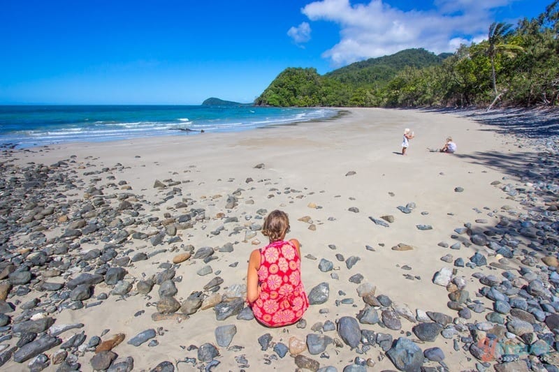 woman sitting on Emmagen Beach - Daintree Rainforest