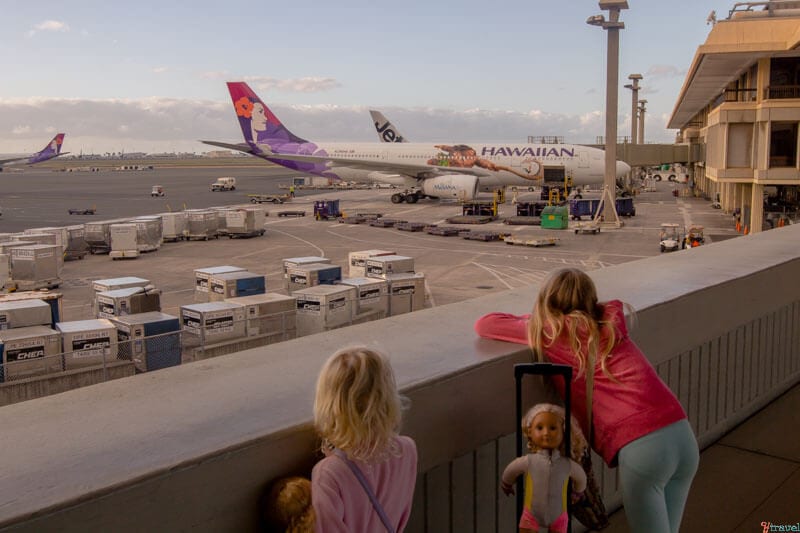 kalyra and savannah looking at aeroplane on runway