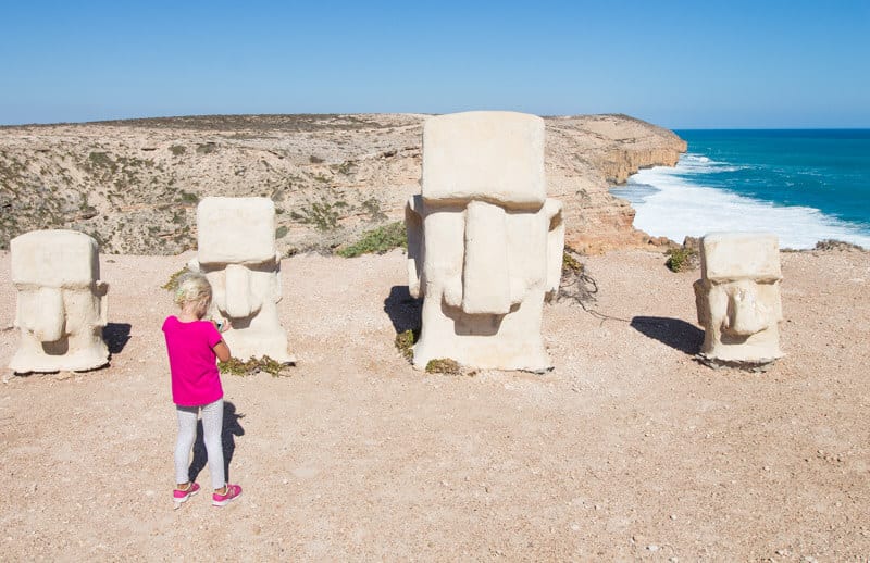 girl looking at statues