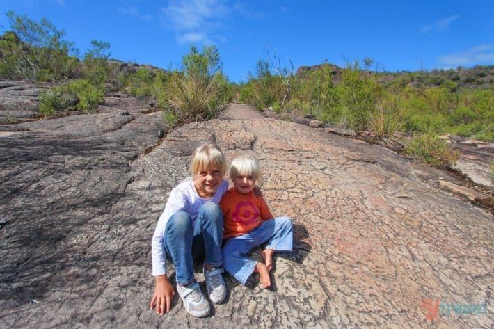 girls sitting on a rock