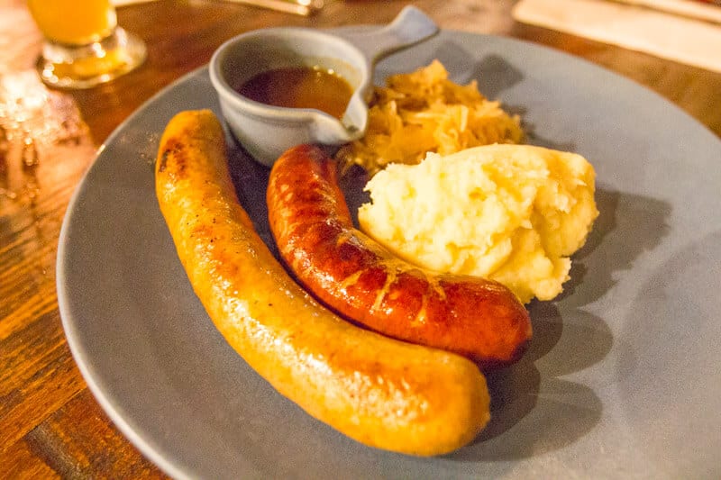 a plate of wurst - kransky and brat with mash and sauerkraut. at Heisenberg Haus in Ipswich, Queensland