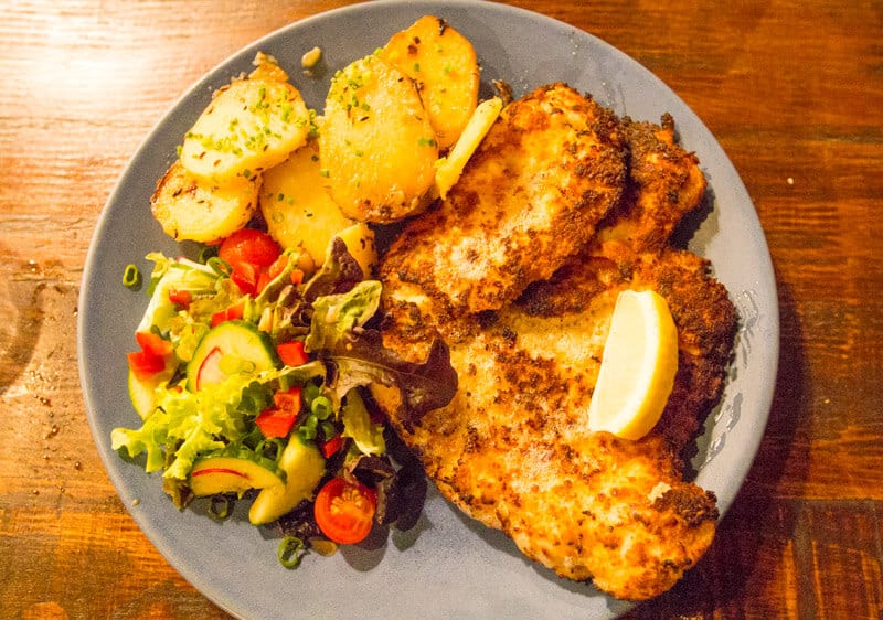 Ginormous chicken schnitzel with pan-fried potatoes at Heisenberg Haus in Ipswich, Queensland