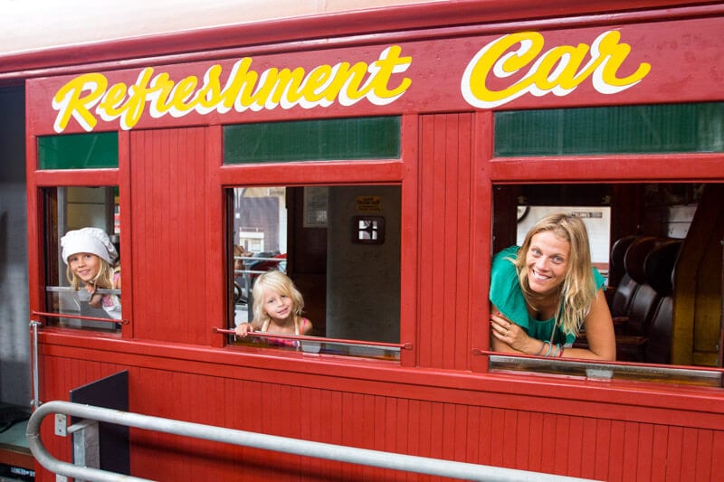 family posing in railway car at Workshop rail museum