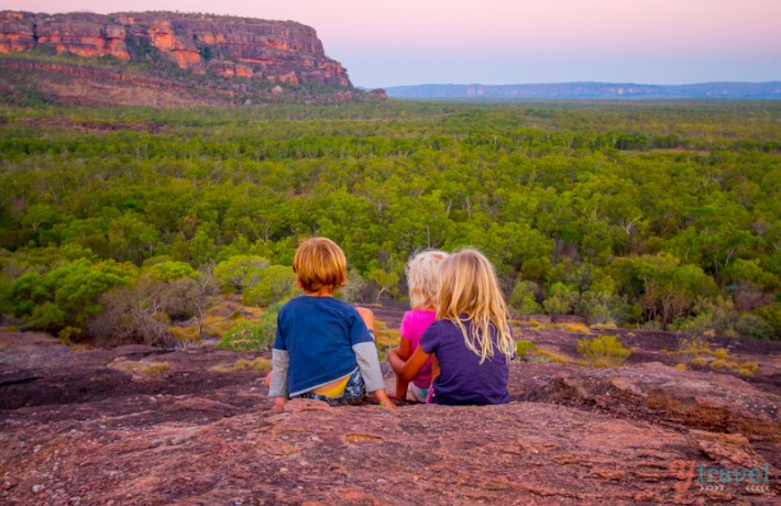 kids sitting on rock looking at sunset in Kakadu National Park, Australia