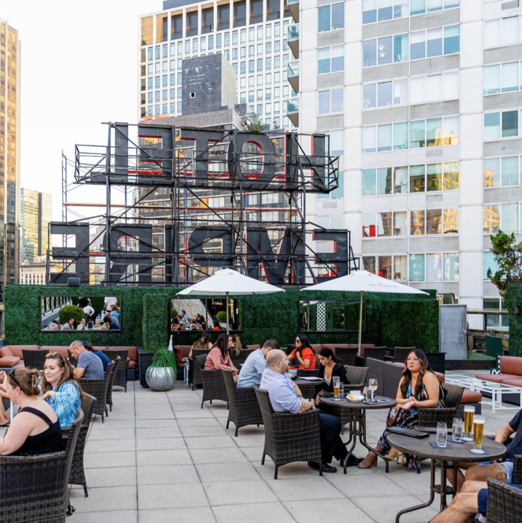 people enjoying the empire hotel rooftop bar