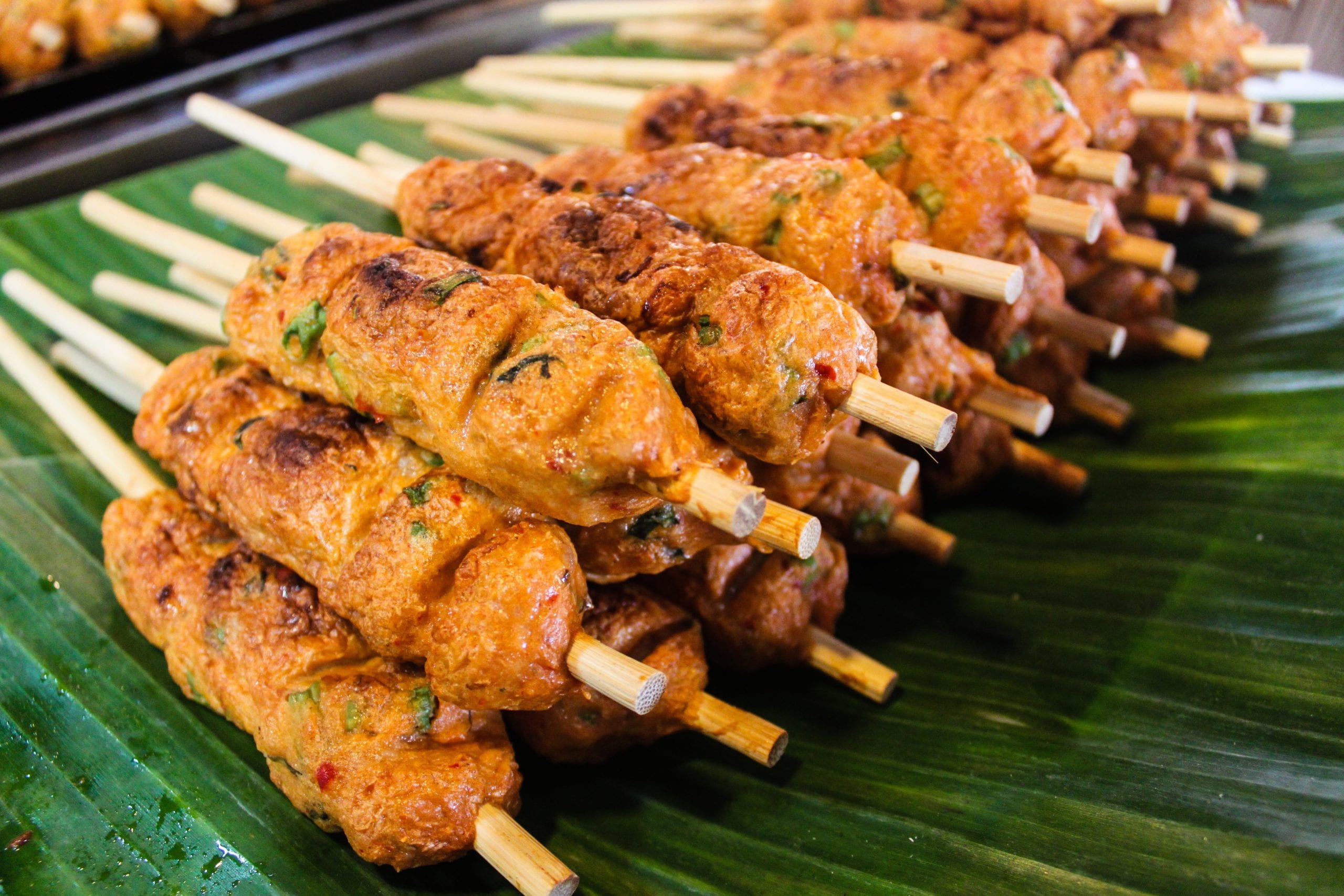 satay sticks on banana leaf