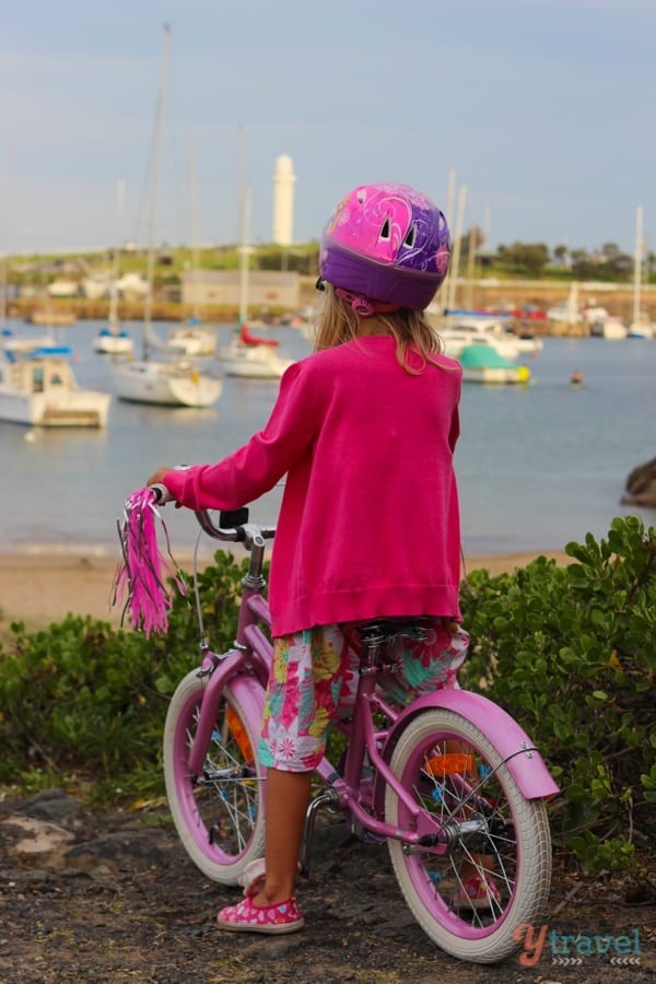 girl on bike looking at harbour views