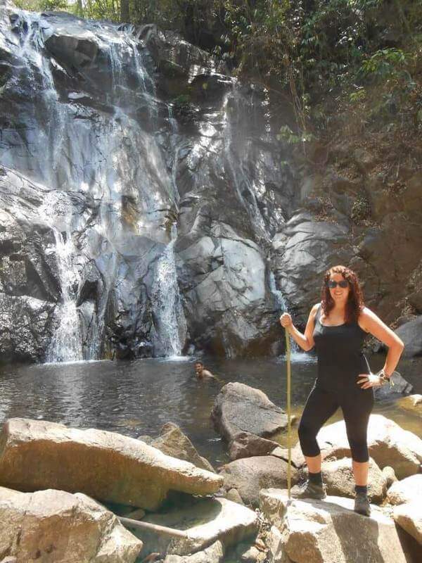 woman beside water fall