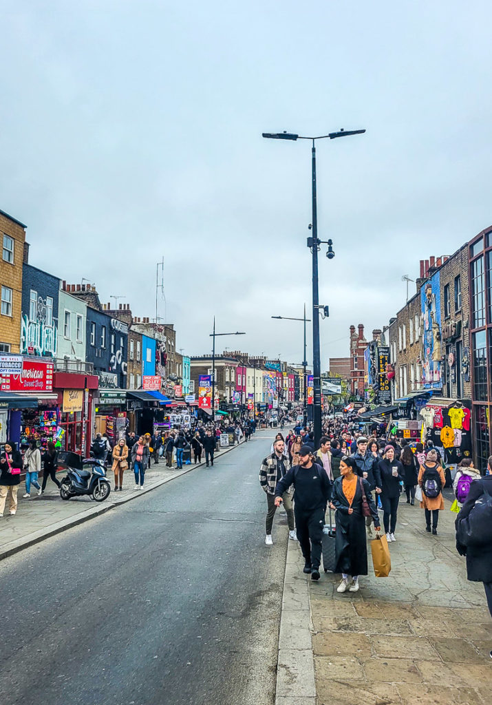 A group of people walking down the street