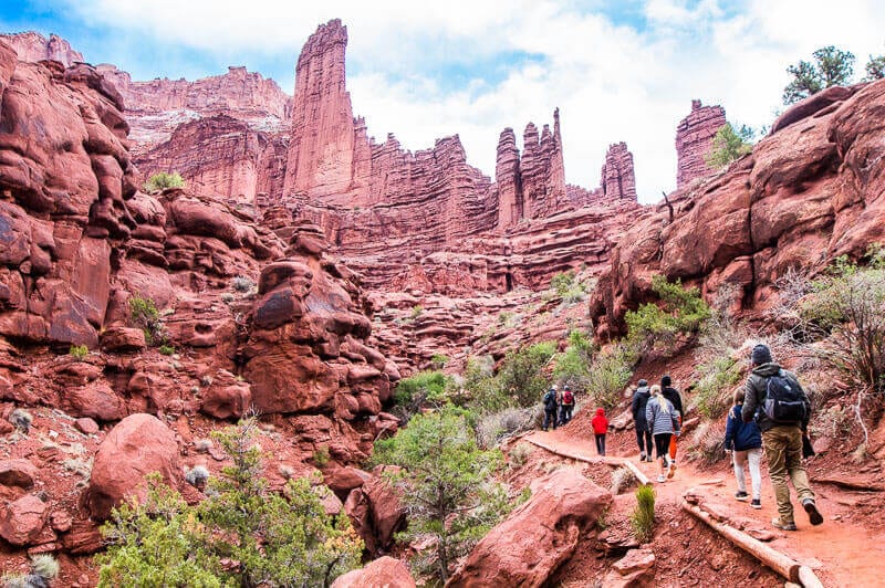 people hiking up Fisher Towers, Utah