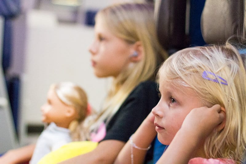 girls sitting on a plane