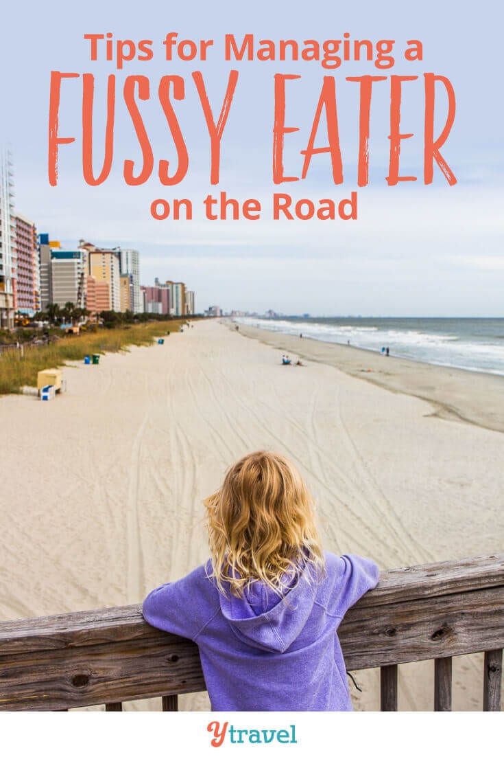 girl standing on a board walk on the beach