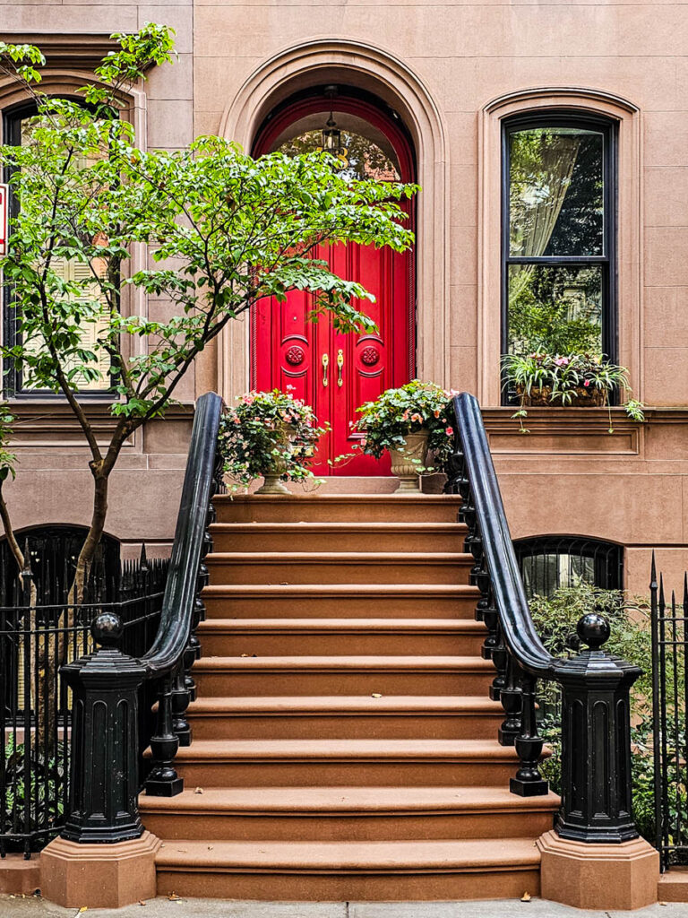 stairs leading to red door in greenwich village