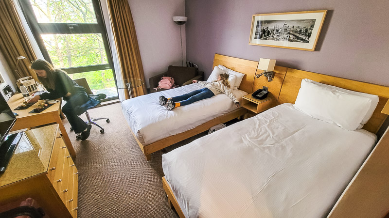 girls on bed in hotel room in london