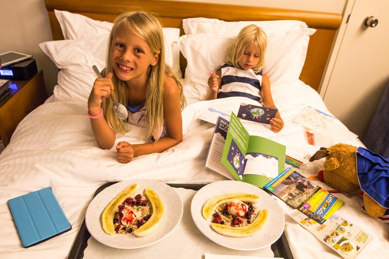 girls eating dessert in hotel bed