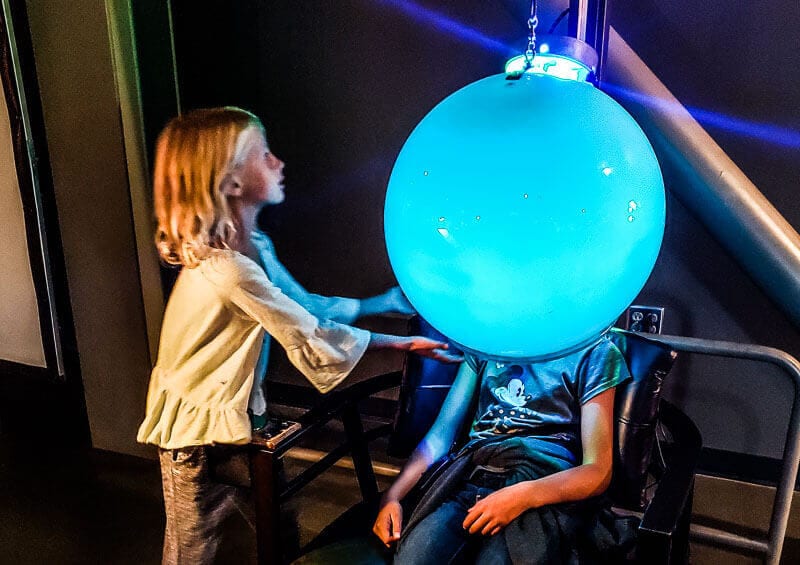 girl engaging with science displays